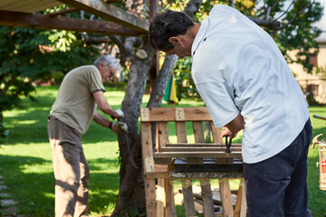 Active senior men working on the backyard