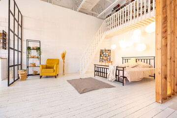 luxury modern design of a cozy small Scandinavian-style studio apartment with white walls, second floor with a library and huge high window full of day light