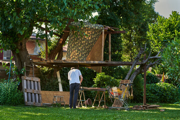 Active senior man in retirement working on the backyard, smiling 