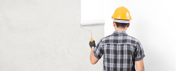 Male in gloves holding painting roller house