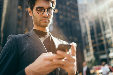 Cropped image of pensive male lawyer in eyewear for vision correction reading incoming notification...