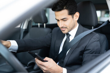 Businessman Using Smartphone In Car