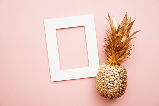 Gold tropical pineapple with blank invitation poster frame