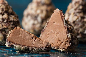 Delicious chocolates in waffle crumbs cut into slices, in half, close-up macro, side view and top view