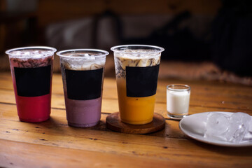 variant of cold drinks with fruit flavor. fresh cafe menu with dark background. colorful ice mockups with plastic cups. grape, chocolate, strawberry, mango, grass jelly,  blueberries, guava