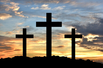 Silhouette Cross Crucifixion Of Jesus Christ on the mountain with sunset background, Easter concept.