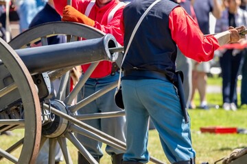 men loading a cannon during an American civil war reenactment 