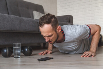 Obraz premium fitness, sport, training and concept - indian man doing push ups at home