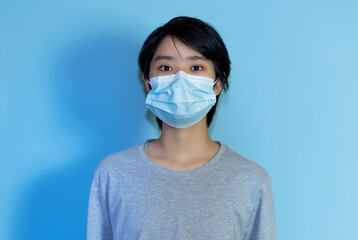 Asian young adult man wearing protection mask to prevent getting sick