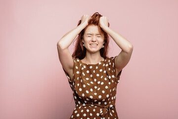 Fototapeta premium The girl screams and experiences strong emotions in the studio
