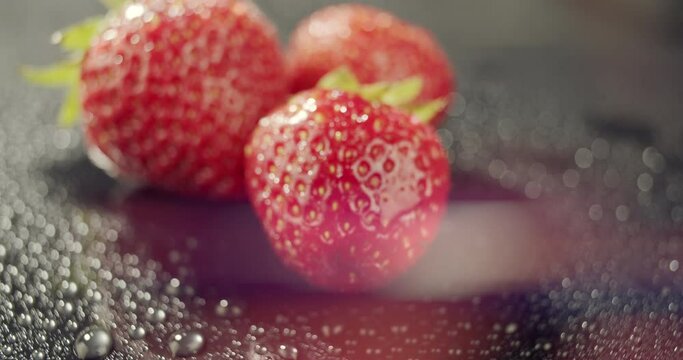 Macro view of red strawberries on dark background.Fresh and juicy berries to eat as dessert, snack, healthy eating concept, nutritious raw food,best for smoothie. Food blogging, advertising, packshot 