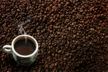 Freshness hot  coffee with coffee beans background
