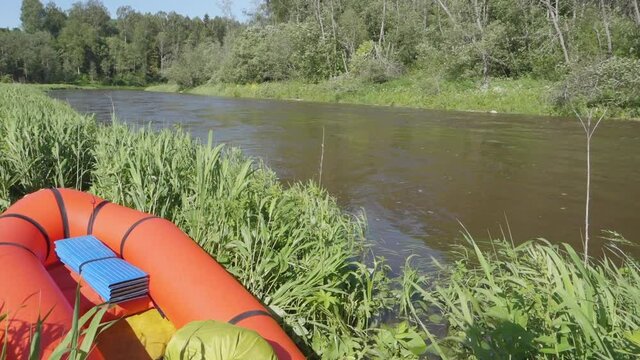 River rafting in summer. Packrafting in wilderness. Raft on the banck of river. Derzha River, Tver Region, Russia.