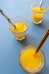 vitamin c orange juice drink with blue background 