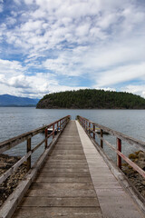 Fototapeta na wymiar Beautiful View of a wooden Quay with Howe Sound and Hutt Island in Background. Taken in Bowen Island, British Columbia, Canada.