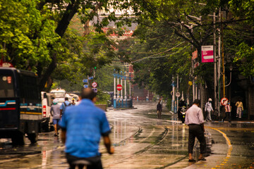 Obraz premium Masked people are walking on road during coronavirus period at Lalbazar Police Headquarters, Kolkata, West Bengal, India on 21st June 2020