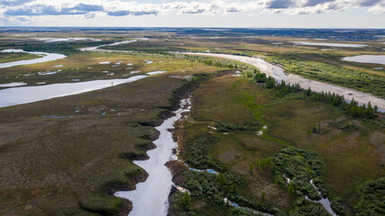 Landscape of the forest-tundra and the sandy river bank, bird's eye view.Arctic Circle, tunda. Beautiful landscape of  tundra from a helicopter.