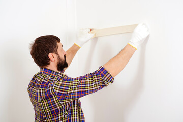 Painter man at work. Skillful and professional painter. Construction and renovation.