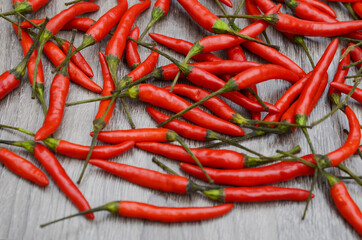 Red hot chili peppers over wooden table. Top view