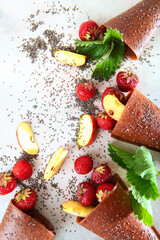 Strawberry pastille and Chia seeds are scattered on a white background with Apple slices. Copy of the space. The concept of still life.Top view.Vertical photo.