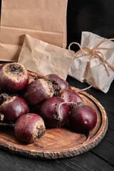 Organic selective beets on a wooden board on a dark background