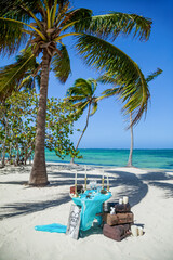 Decorative table with wedding accessories settings, decoration, flowers and decor for beach outdoor tropical wedding matrimonial marriage ceremony 