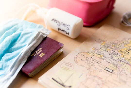 close up of hands with medical gloves holding passport, a symbol of the new border checks following the coronavirus spread and globla contagion. the travel and tourism industries face a big issue due 