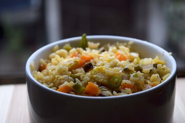 Baby corn fried rice serving on white bowl. Fried rice into a white bowl
