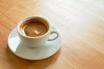 Serving white espresso cups placed on wooden floors.
