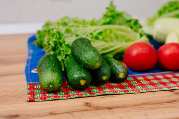 Fresh vegetables. Fresh wash vegetables lie on the table in the kitchen. Vegetables cooked for slicing into a salad. Cooking Salad. Vegetarian cuisine.
