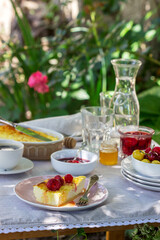 Breakfast in the garden from casseroles, berries, sauces and drinks. Rustic style.