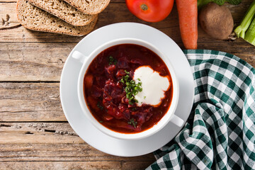 Traditional Ukrainian Russian borsch. Beetroot soup on wooden table.  Top view	