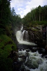 Beautiful waterfall by a mill surrounded by Norwegian nature