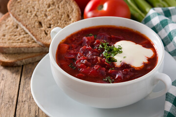 Traditional Ukrainian Russian borsch. Beetroot soup on wooden table.	