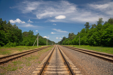 Fototapeta na wymiar Railroad tracks in a rural scene with beautiful scenery.