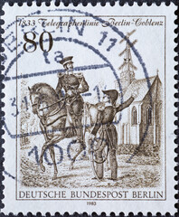 GERMANY, Berlin - CIRCA 1983: a postage stamp from Germany, Berlin showing Royal Prussian telegraph inspectors in front of the Dahlem village church. 150 years of the Berlin – Coblenz telegraph line