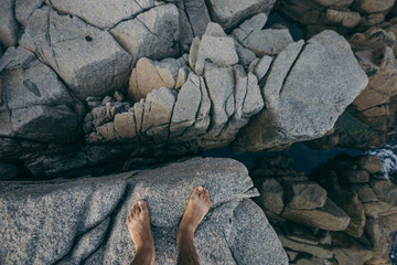 A person lying on a rock