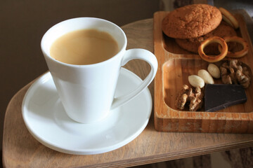 Coffee in a cup and nuts for breakfast