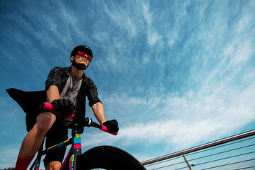 Man ride a bicycle at bridge.