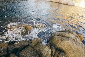 A close up of a rock next to a body of water