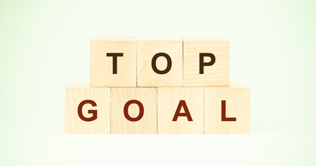 words top goal with black letters on small wooden cubes