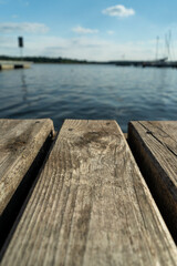 Fototapeta premium View from the pier to the lake on a sunny summer day. Time for rest and vacation.