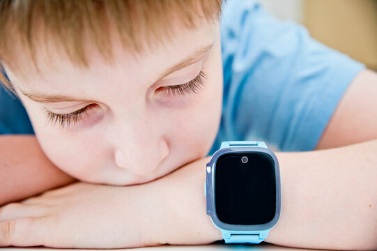Boy with a smart watch. Children and modern technology. Player on hand.