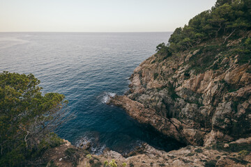 Fototapeta na wymiar A rocky island in the middle of a body of water