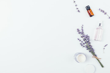 Flat lay composition with natural skin care cosmetics and lavender flowers
