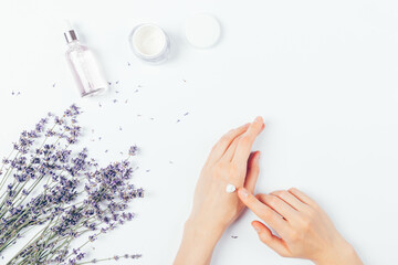 Woman's hands apply skin care cream