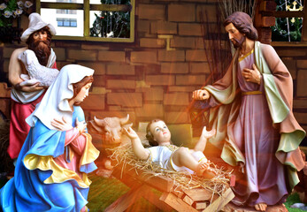 Statuettes of Mary, Joseph and baby Jesus,The birthday of Jesus is a statuette of Maria with Joseph and newborn Jesus on the hay, A Christmas nativity scene. © masterjew