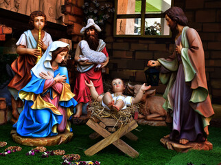 Obraz premium Statuettes of Mary, Joseph and baby Jesus,The birthday of Jesus is a statuette of Maria with Joseph and newborn Jesus on the hay, A Christmas nativity scene.