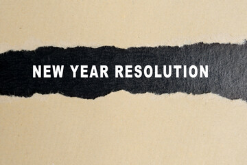 New year resolution words on torn paper background.
