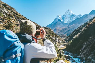 Foto auf Acrylglas Ama Dablam Young hiker backpacker female taking photo mountain view during high altitude Acclimatization walk. Everest Base Camp trekking route, Nepal. Active landscape photographer vacations concept image.
